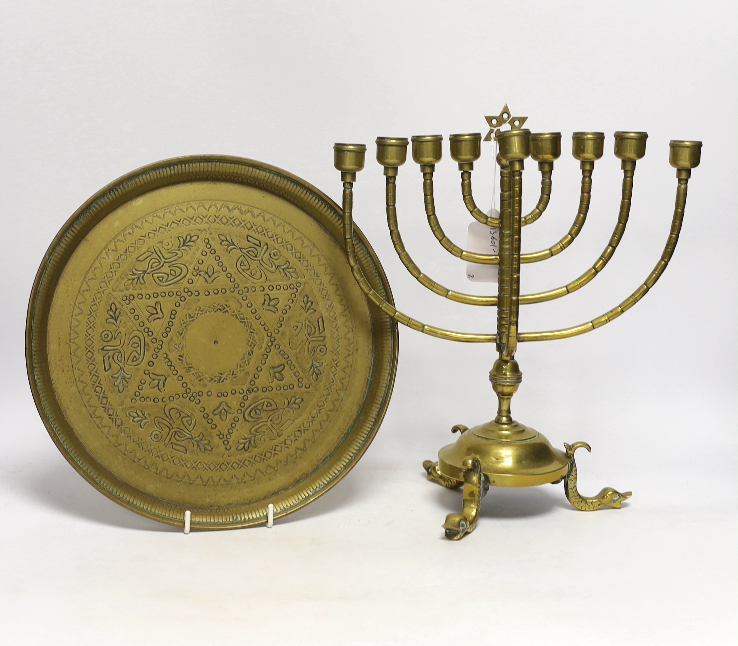 Two pieces of Judaica comprising brass Chanukka and circular dish, largest 31cm high